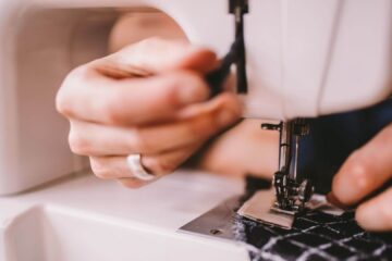 woman sewing dress with sewing machine