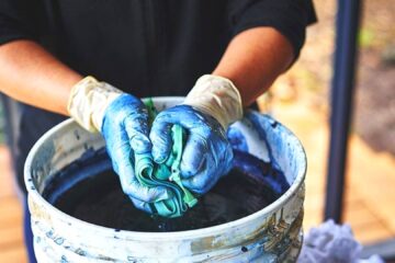 person dying fabric in bucket